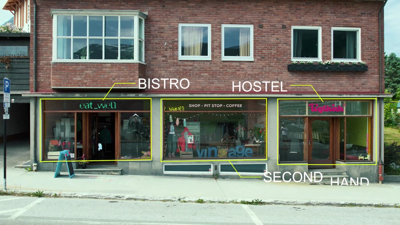 The façade at Gamle Romsdalsvegen 10, with its bistro, hostel and second-hand signs